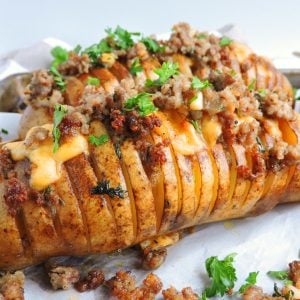 Spicy Smoked Gouda & Sausage Hasselback Potatoes made with Odom's Tennessee Pride Mild Sausage, topped with rosemary and parsley