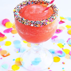 Frozen Fruity Birthday Cocktail poured in a large margarita glass with sprinkles around the rim