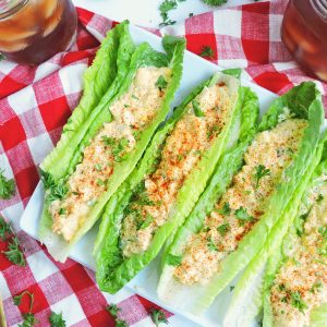 Cajun Herb Egg Salad served in romaine lettuce wraps on a red and white checkerboard tablecloth