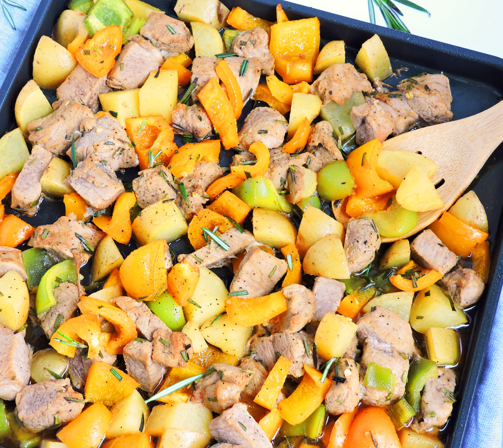 Honey Balsamic Pork & Veggie Sheet Pan Meal on a white surface made with the Ninja® Foodi™ Digital Air Fry Oven.