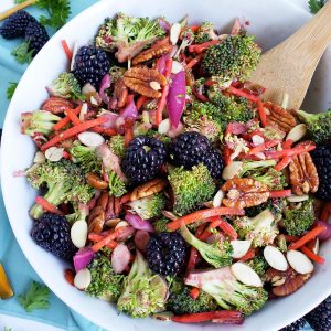 Vegan Blackberry Broccoli Salad made with Oregon blackberries, pecans, almonds, and carrots in a white bowl