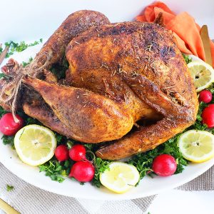 Cajun & Herb Slow-Roasted Turkey, cooked overnight, on a white serving platter