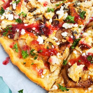 Roasted Turkey, Feta, & Cranberry Pizza made with Thanksgiving leftovers and a cranberry vinaigrette.