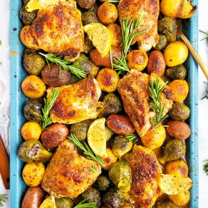 This Lemony Rosemary Sheet Pan Chicken with Brussels Sprouts & Potatoes the perfect weeknight meal; made on a blue sheet pan with chicken thighs, roasted potatoes, Brussels sprouts, lemon wedges and rosemary. beautifuleatsandthings.com