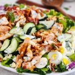 Salmon Cobb Salad topped with a creamy dill dressing served on a white platter beautifuleatsandthings.com