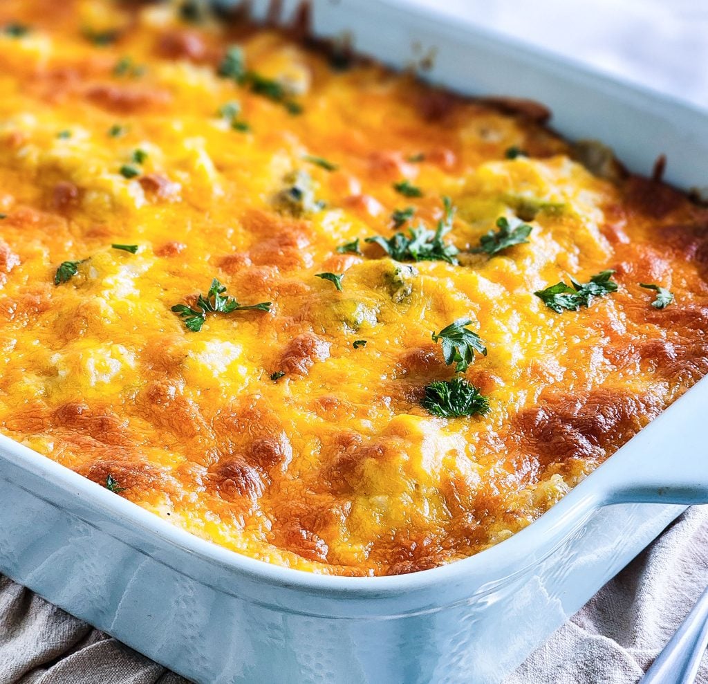 Budget-Friendly Cheesy Chicken & Broccoli Casserole for under $15 cooked in a light blue baking dish
beautifuleatsandthings.com
