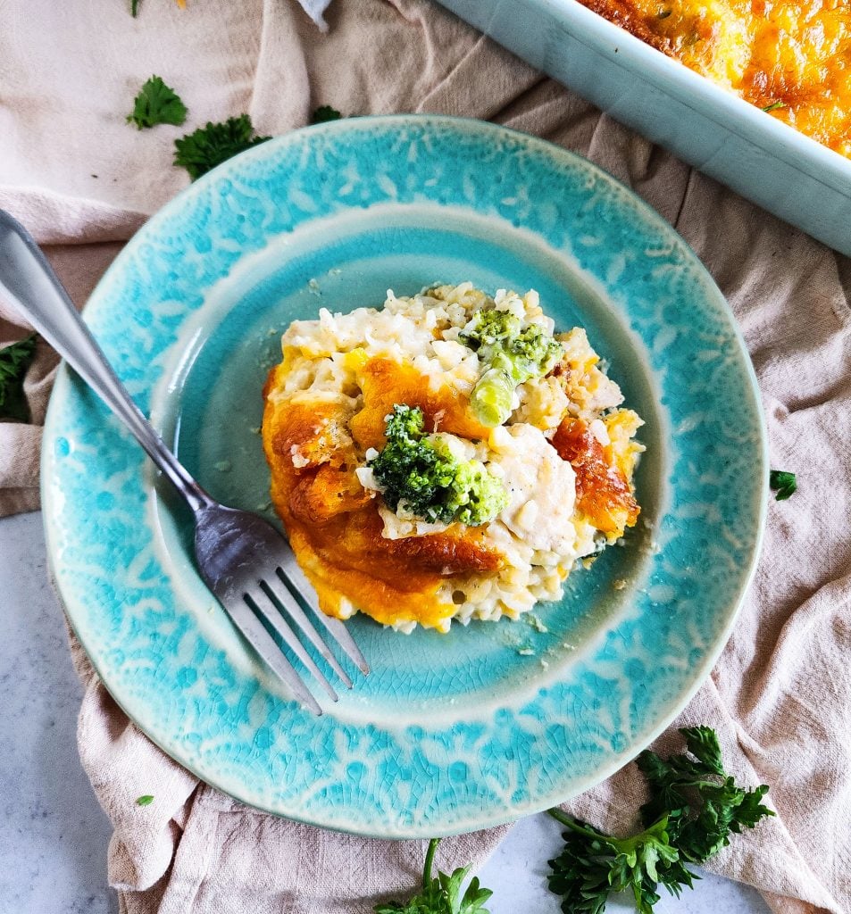 Budget-Friendly Cheesy Chicken & Broccoli Casserole for under $15 cooked in a light blue baking dish
beautifuleatsandthings.com