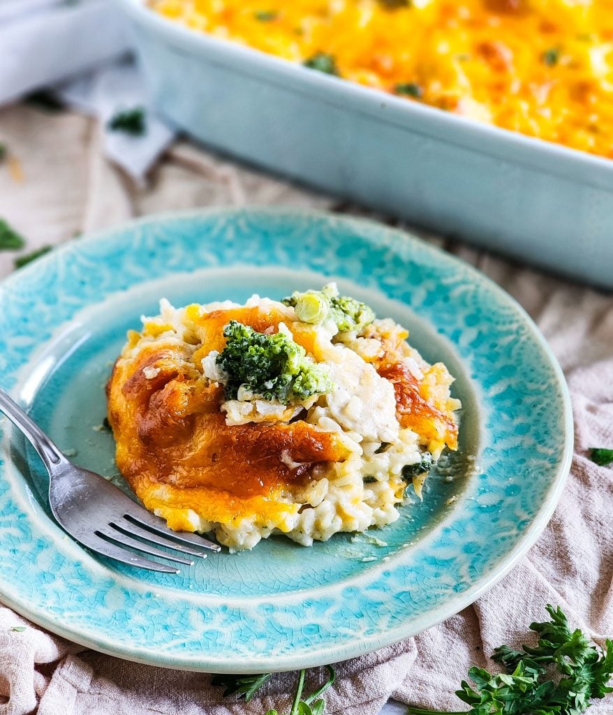 Budget-Friendly Cheesy Chicken & Broccoli Casserole for under $15 cooked in a light blue baking dish
beautifuleatsandthings.com