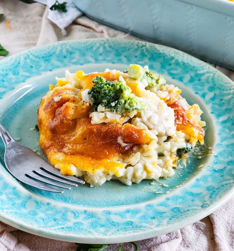 Budget-Friendly Cheesy Chicken & Broccoli Casserole for under $15 cooked in a light blue baking dish
beautifuleatsandthings.com