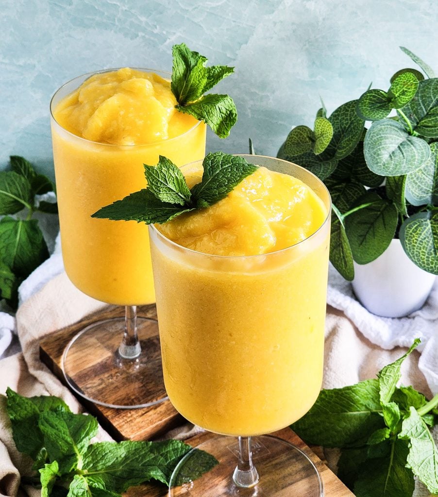 Passionfruit Mango Pineapple Frosé in a cocktail glass topped with fresh mint
beautifuleatsandthings.com