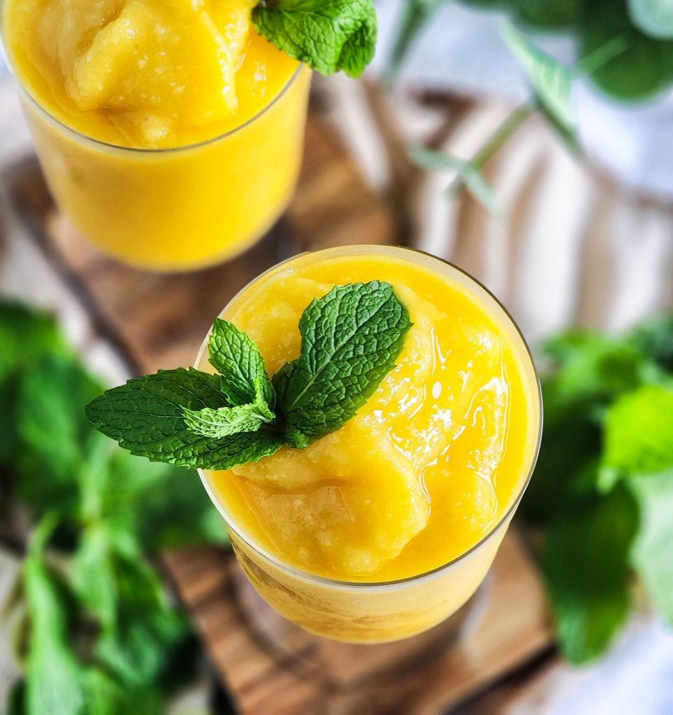 Passionfruit Mango Pineapple Frosé in a cocktail glass topped with fresh mint
beautifuleatsandthings.com