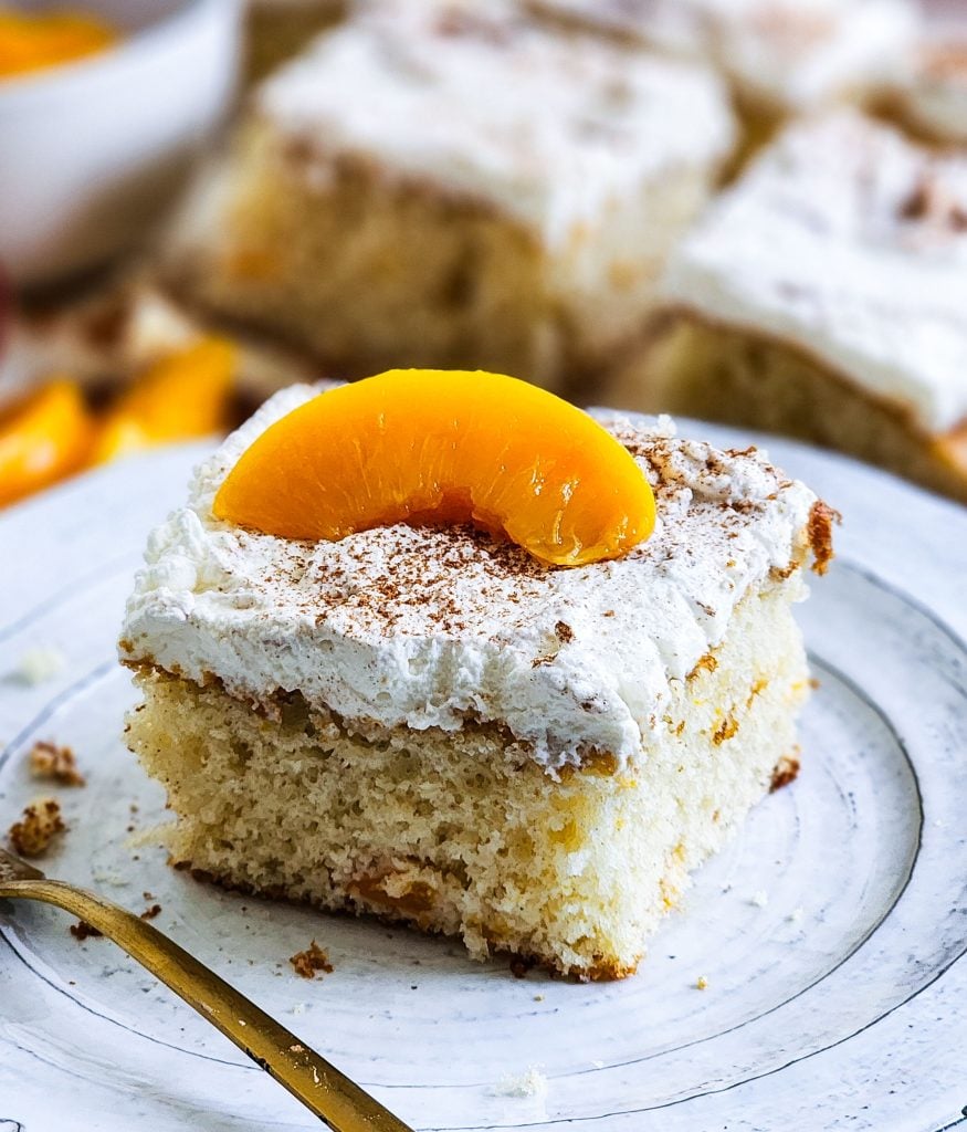 Light & Fluffy Peach Cake made with cake mix and whipped cream frosting and canned peaches beautifuleatsandthings.com