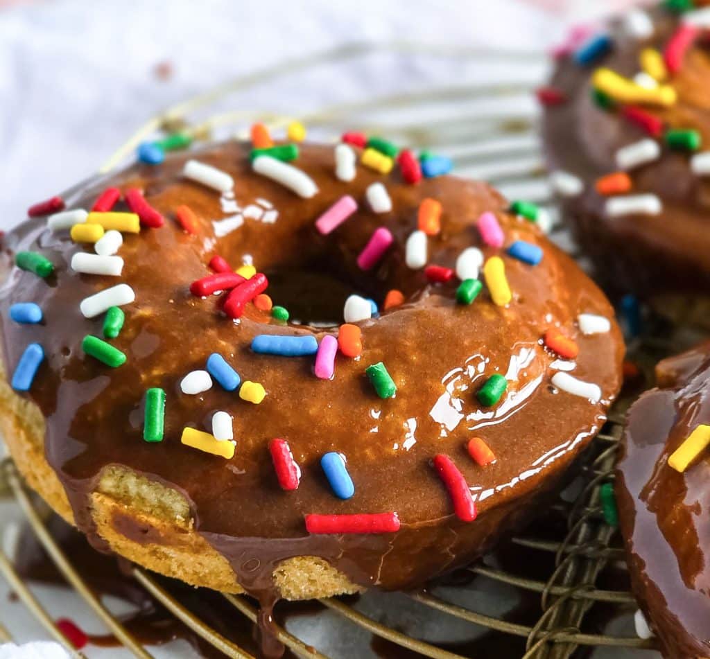oat flour donuts topped with a chocolate glaze and colorful sprinkles
beautifuleatsandthings.com