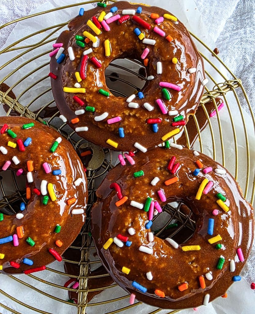 oat flour donuts topped with a chocolate glaze and colorful sprinkles
beautifuleatsandthings.com