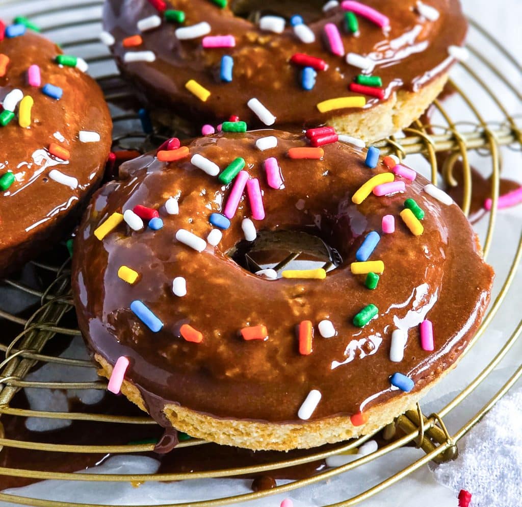 oat flour donuts topped with a chocolate glaze and colorful sprinkles
beautifuleatsandthings.com