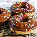 oat flour donuts topped with a chocolate glaze and colorful sprinkles beautifuleatsandthings.com