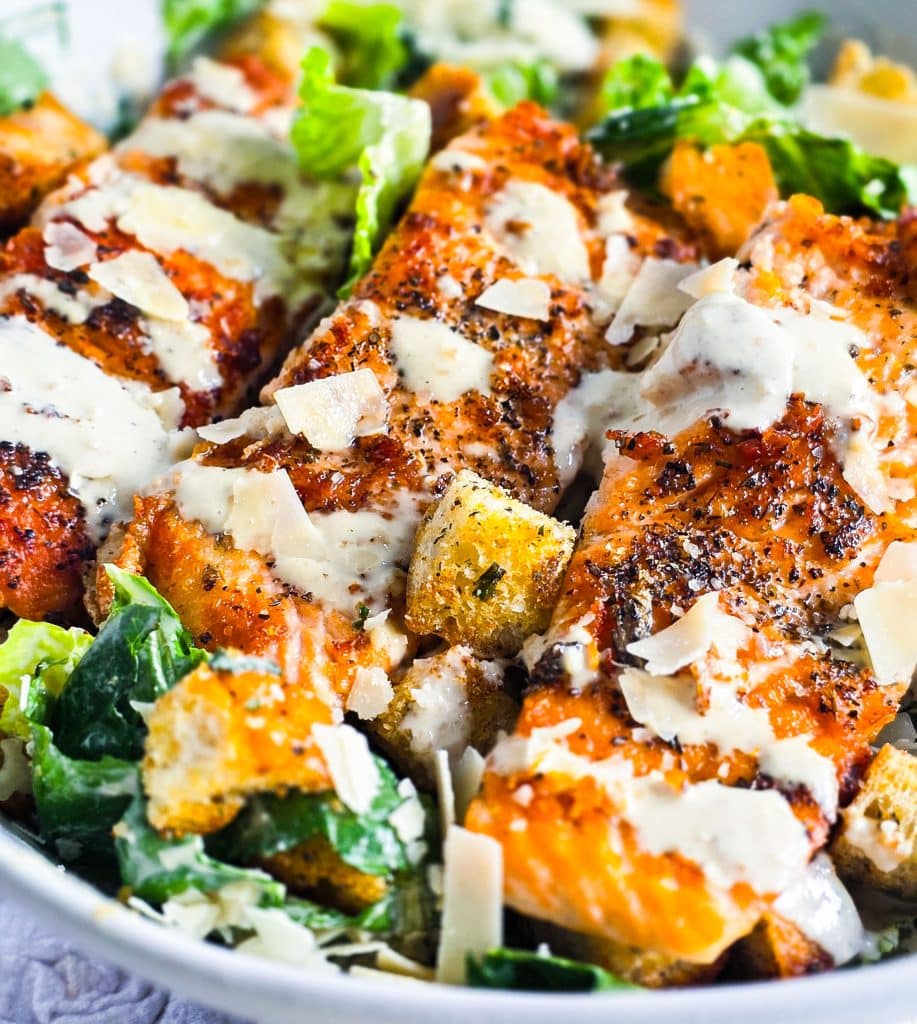 easy salmon Caesar salad, seared and plated in a white bowl topped with homemade caesar dressing and homemade croutons
beautifuleatsandthings.com