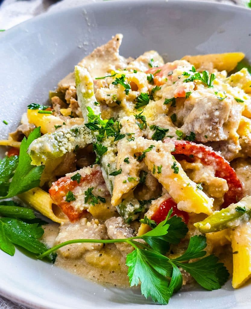 Easy Crockpot Philly Cheesesteak Pasta made in a black slow cooker with red and green bell peppers
beautifuleatsandthings.com