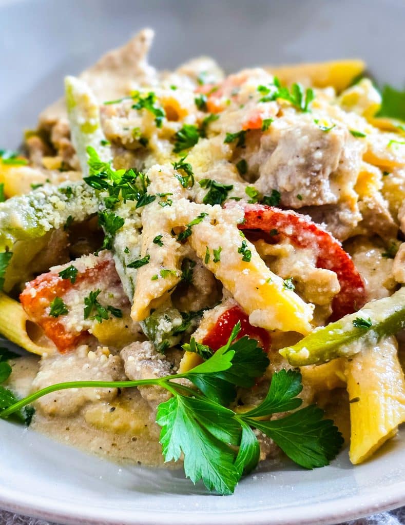 Easy Crockpot Philly Cheesesteak Pasta made in a black slow cooker with red and green bell peppers
beautifuleatsandthings.com
