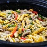Easy Crockpot Philly Cheesesteak Pasta made in a black slow cooker with red and green bell peppers beautifuleatsandthings.com