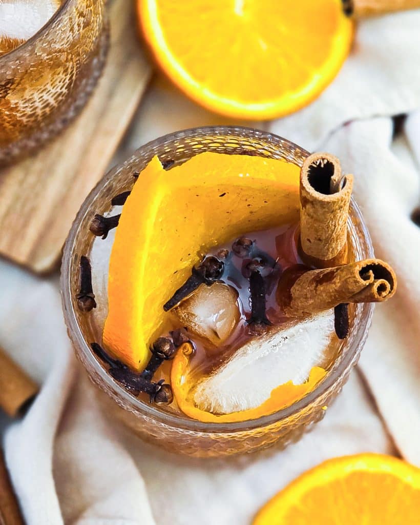 vanilla spice old fashioned cocktail in a lowball glass served with cinnamon sticks and orange slices
beautifuleatsandthings.com