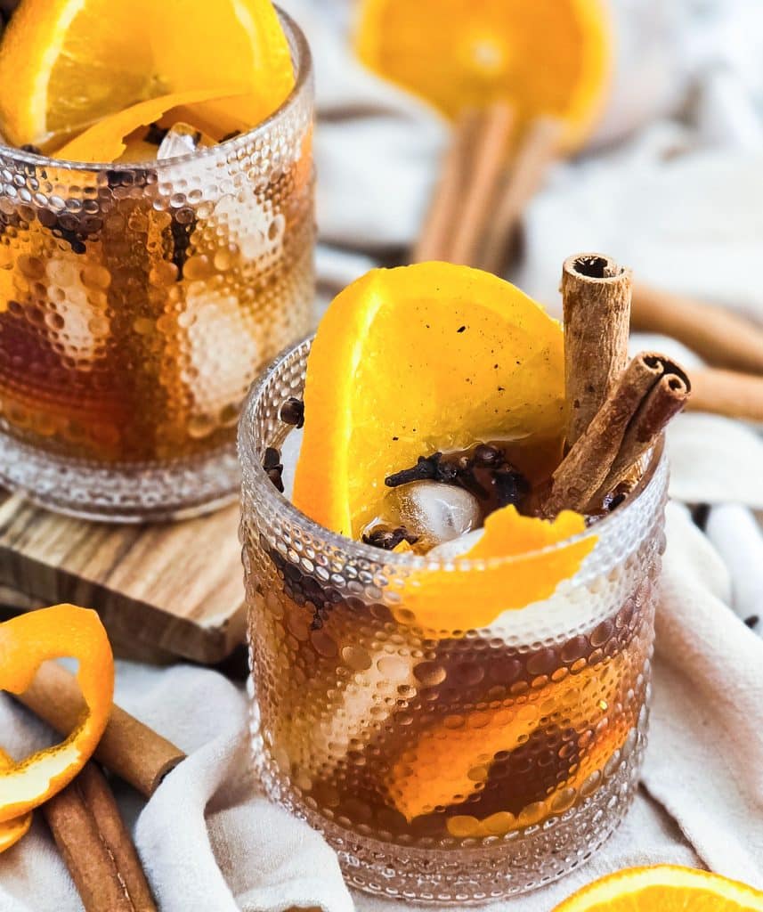 vanilla spice old fashioned cocktail in a lowball glass served with cinnamon sticks and orange slices
beautifuleatsandthings.com