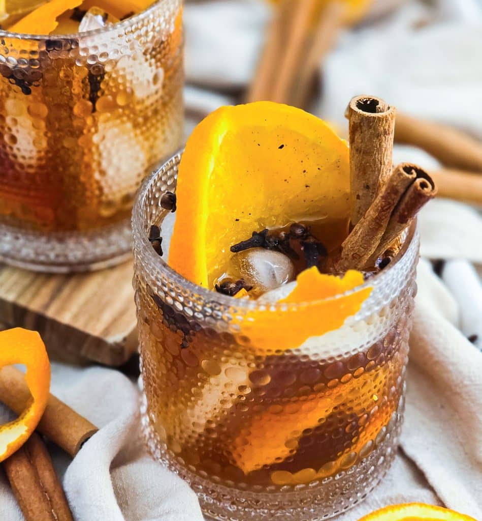 vanilla spice old fashioned cocktail in a lowball glass served with cinnamon sticks and orange slices
beautifuleatsandthings.com