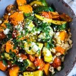 healthy high fiber grain bowl with zucchini, sweet potatoes, and tomatoes served over cooked barley in a gray bowl beautifuleatsandthings.com