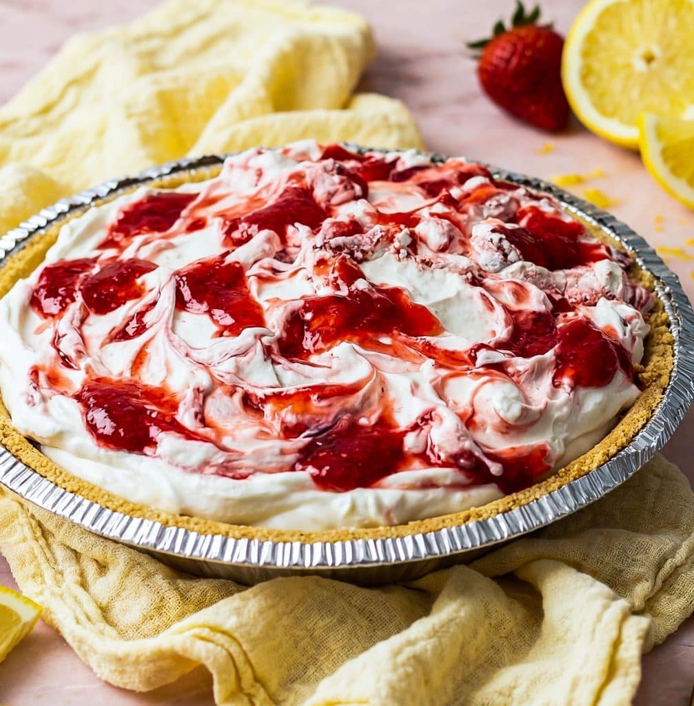 No bake strawberry lemon icebox pie with graham cracker crust on a pink marble surface
beautifuleatsandthings.com