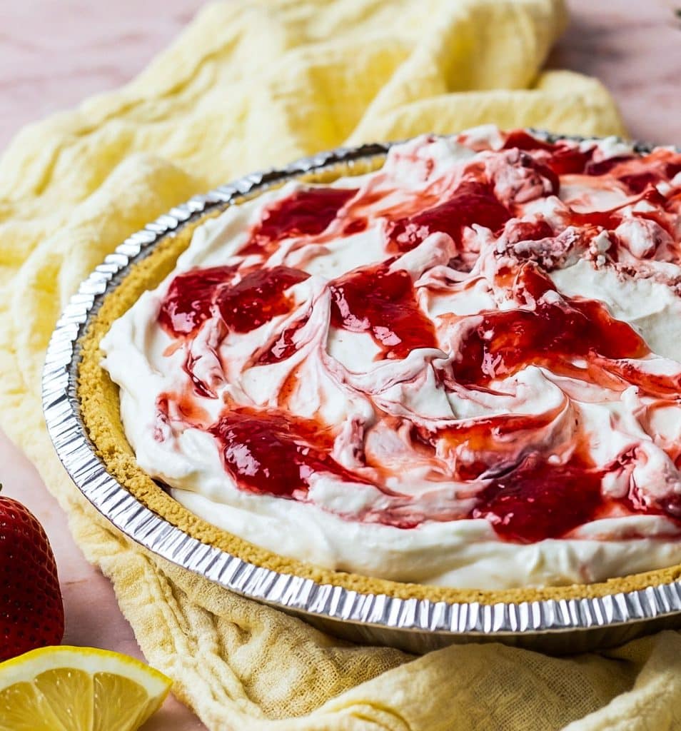No bake strawberry lemon icebox pie with graham cracker crust on a pink marble surface
beautifuleatsandthings.com