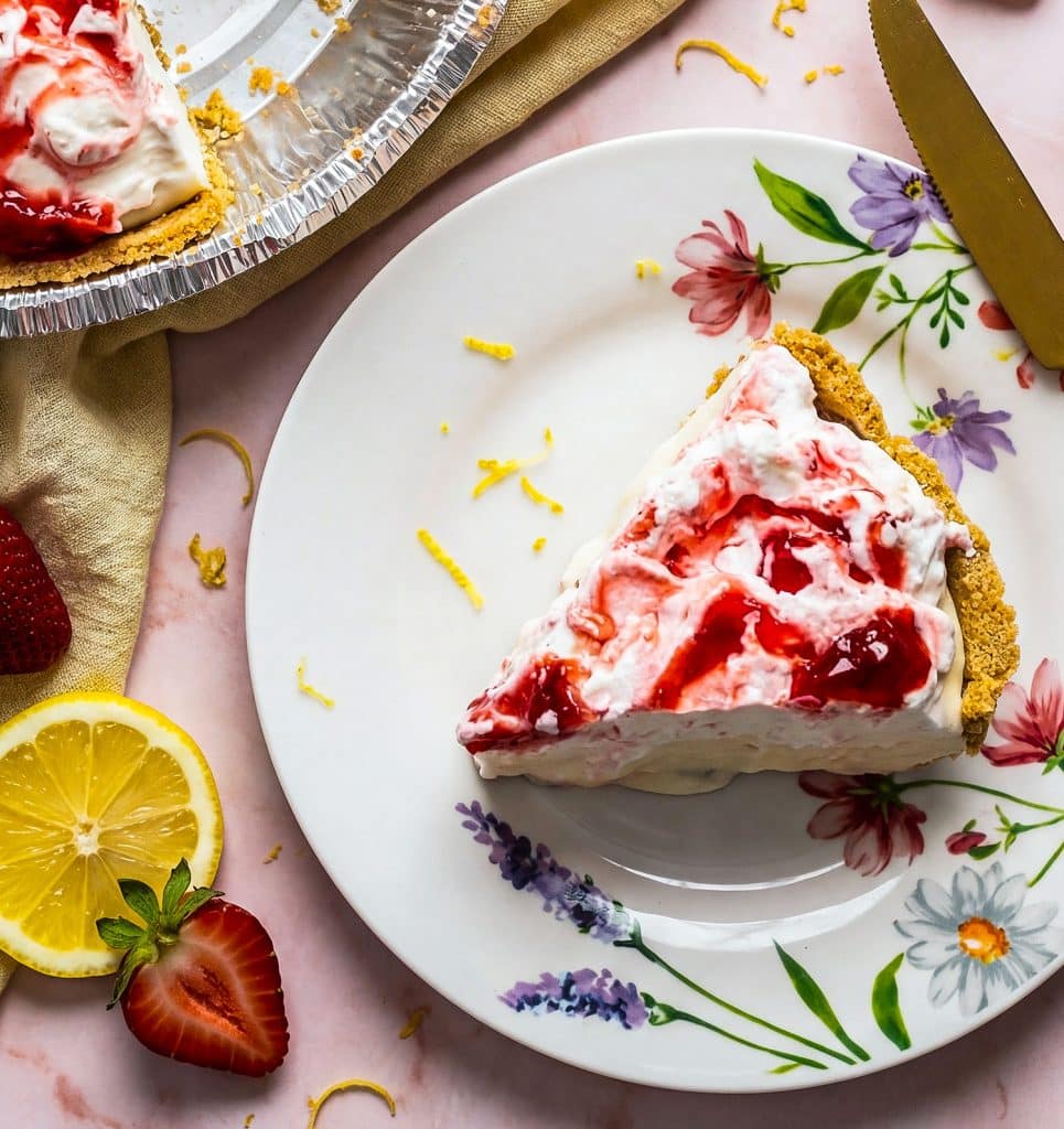 No bake strawberry lemon icebox pie with graham cracker crust on a pink marble surface
beautifuleatsandthings.com