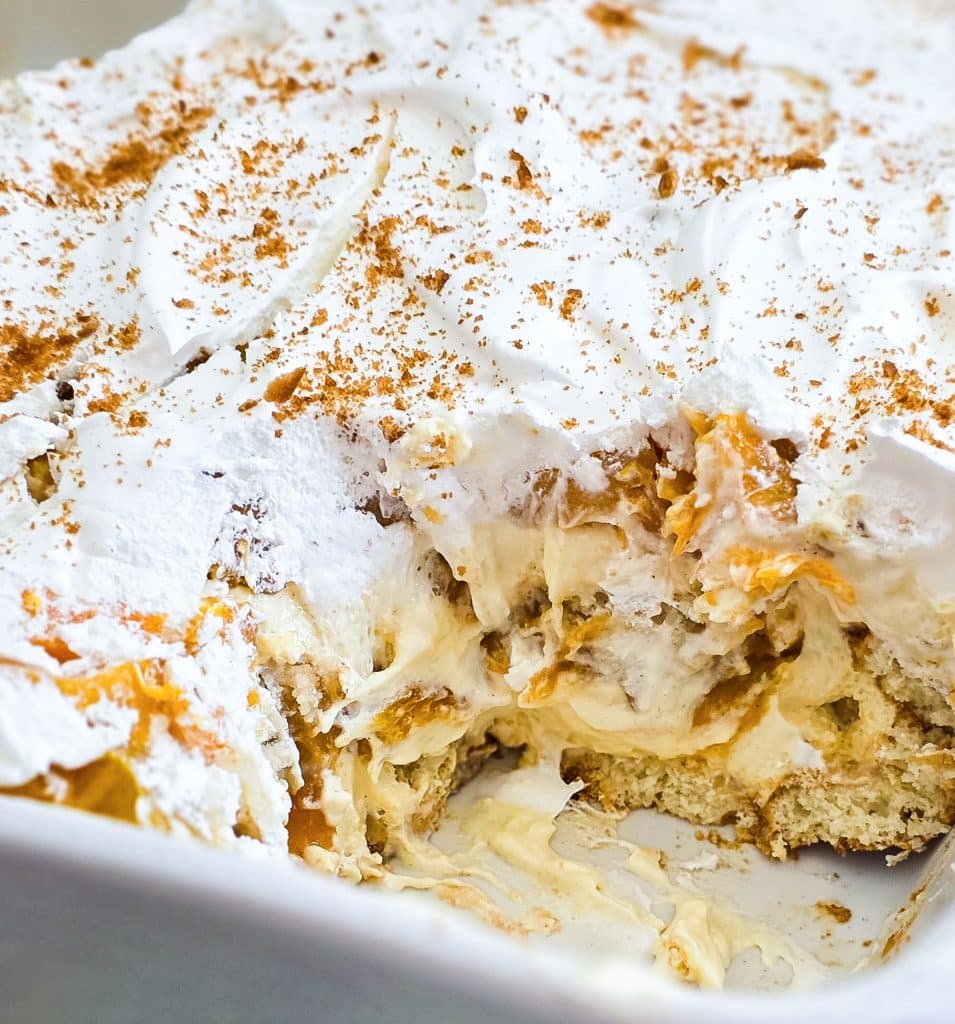 Easy no-bake peach pudding made with canned peaches, whipped topping, and vanilla wafers layered in a glass dish, served on a blue plate beautifuleatsandthings.com