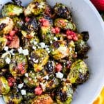 Crispy Oven Roasted Brussels Sprouts with Strawberry Lemonade Flavor, in a white bowl with crumbled feta cheese beautifuleatsandthings.com