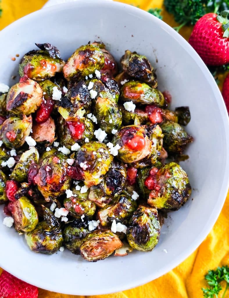 Crispy Oven Roasted Brussels Sprouts with Strawberry Lemonade Flavor, in a white bowl with crumbled feta cheese
beautifuleatsandthings.com