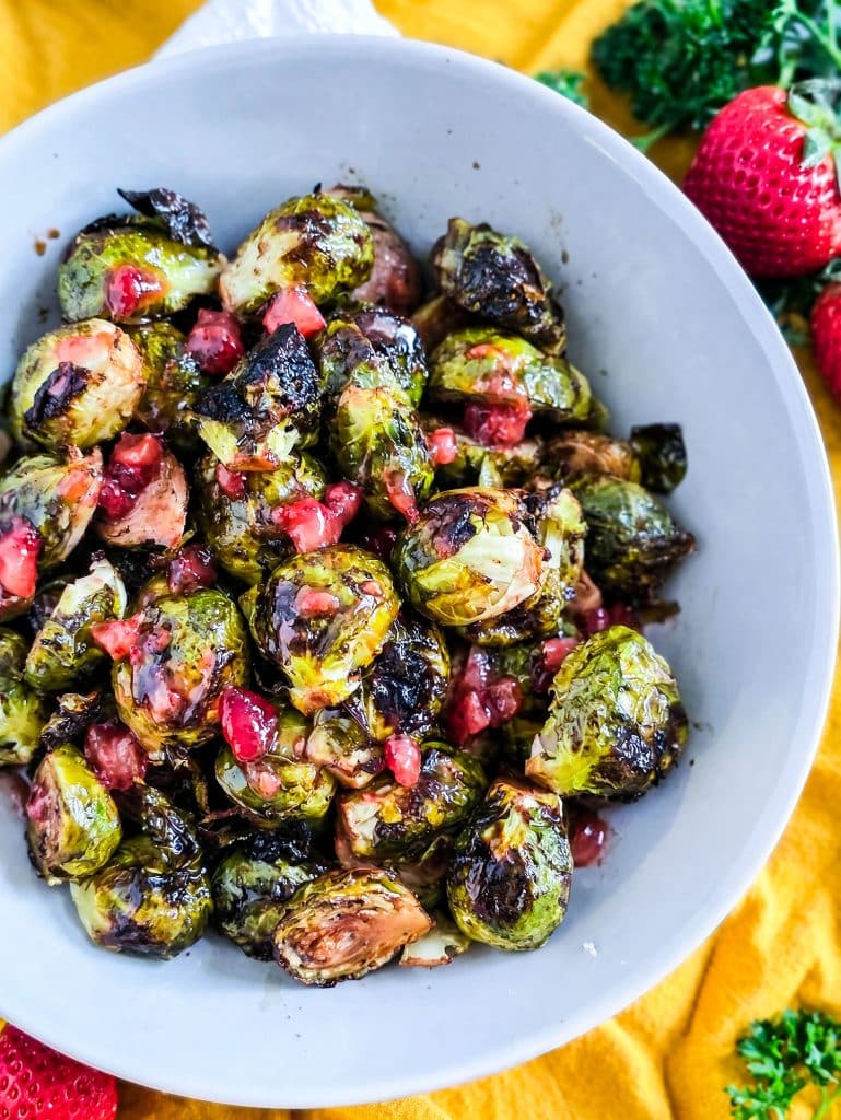 Crispy Oven Roasted Brussels Sprouts with Strawberry Lemonade Flavor, in a white bowl with crumbled feta cheese
beautifuleatsandthings.com
