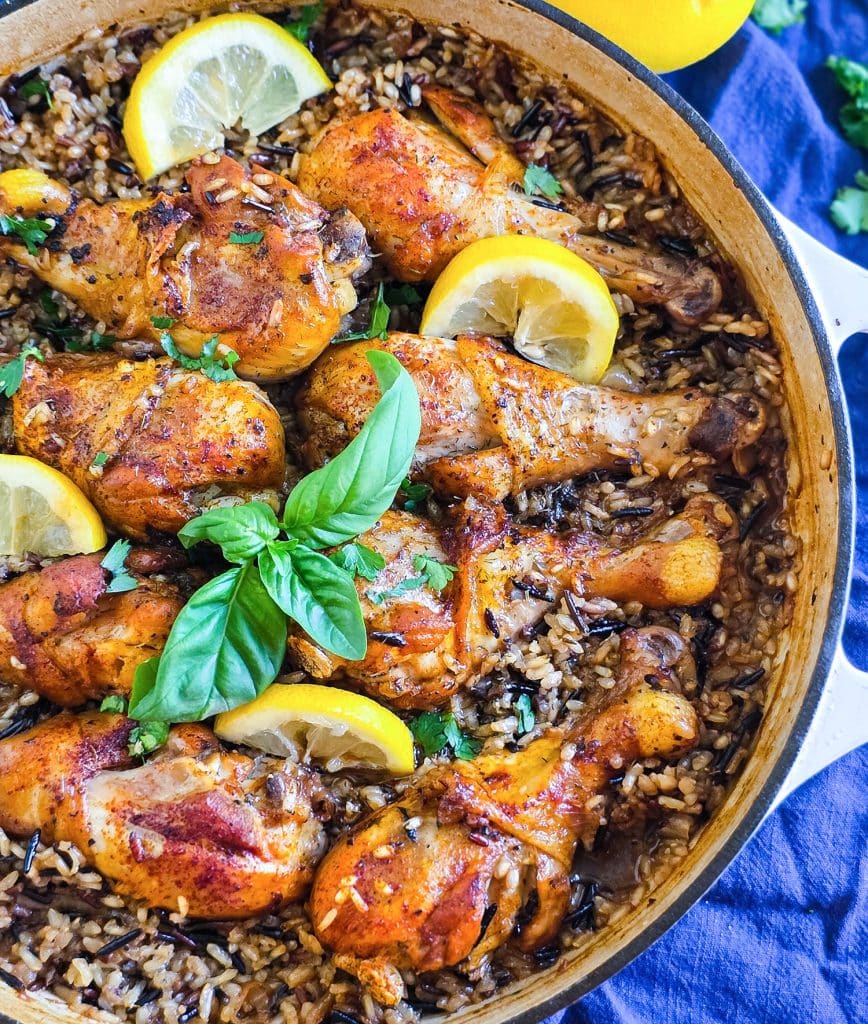 One pot lemon basil chicken with wild rice in skillet garnished with fresh basil and lemon slices beautifuleatsandthings.com