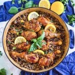 One pot lemon basil chicken with wild rice in skillet garnished with fresh basil and lemon slices beautifuleatsandthings.com