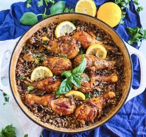 One pot lemon basil chicken with wild rice in skillet garnished with fresh basil and lemon slices beautifuleatsandthings.com