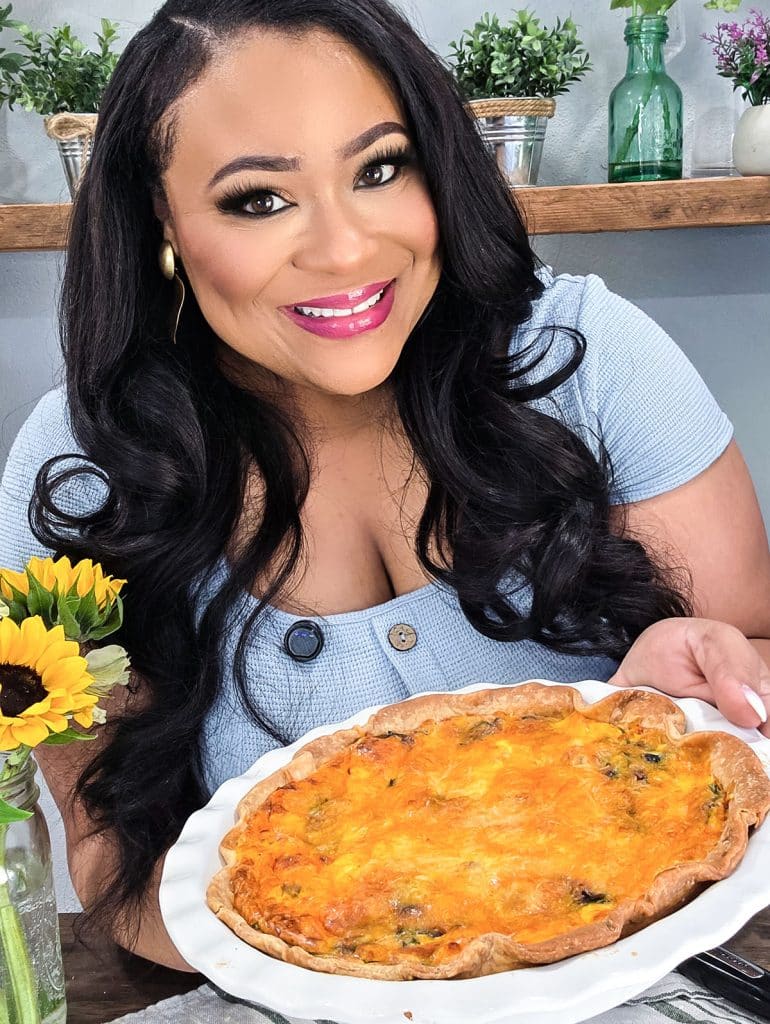 Black registered dietitian, food influencer, southern belle holding up a quiche. beautifuleatsandthings.com