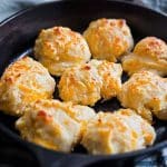 Easy homemade drop cheese biscuits baked in a cast iron skillet until golden brown, topped with melted butter beautifuleatsandthings.com