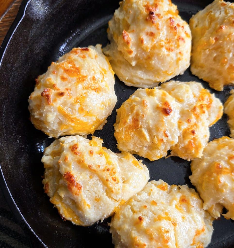 Easy homemade drop cheese biscuits baked in a cast iron skillet until golden brown, topped with melted butter
beautifuleatsandthings.com