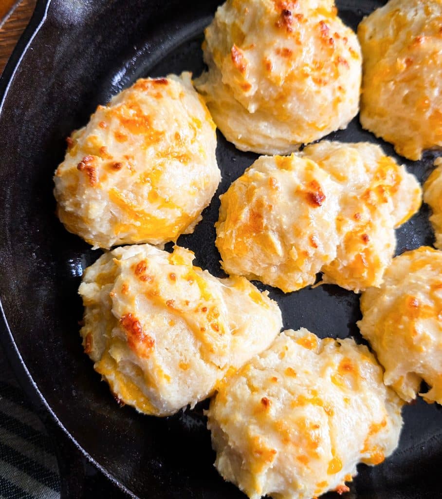 Easy homemade drop cheese biscuits baked in a cast iron skillet until golden brown, topped with melted butter
beautifuleatsandthings.com