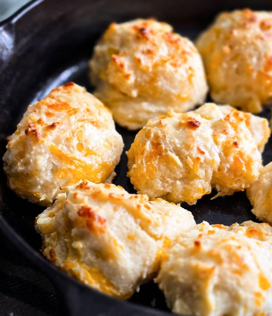 Easy homemade drop cheese biscuits baked in a cast iron skillet until golden brown, topped with melted butter
beautifuleatsandthings.com